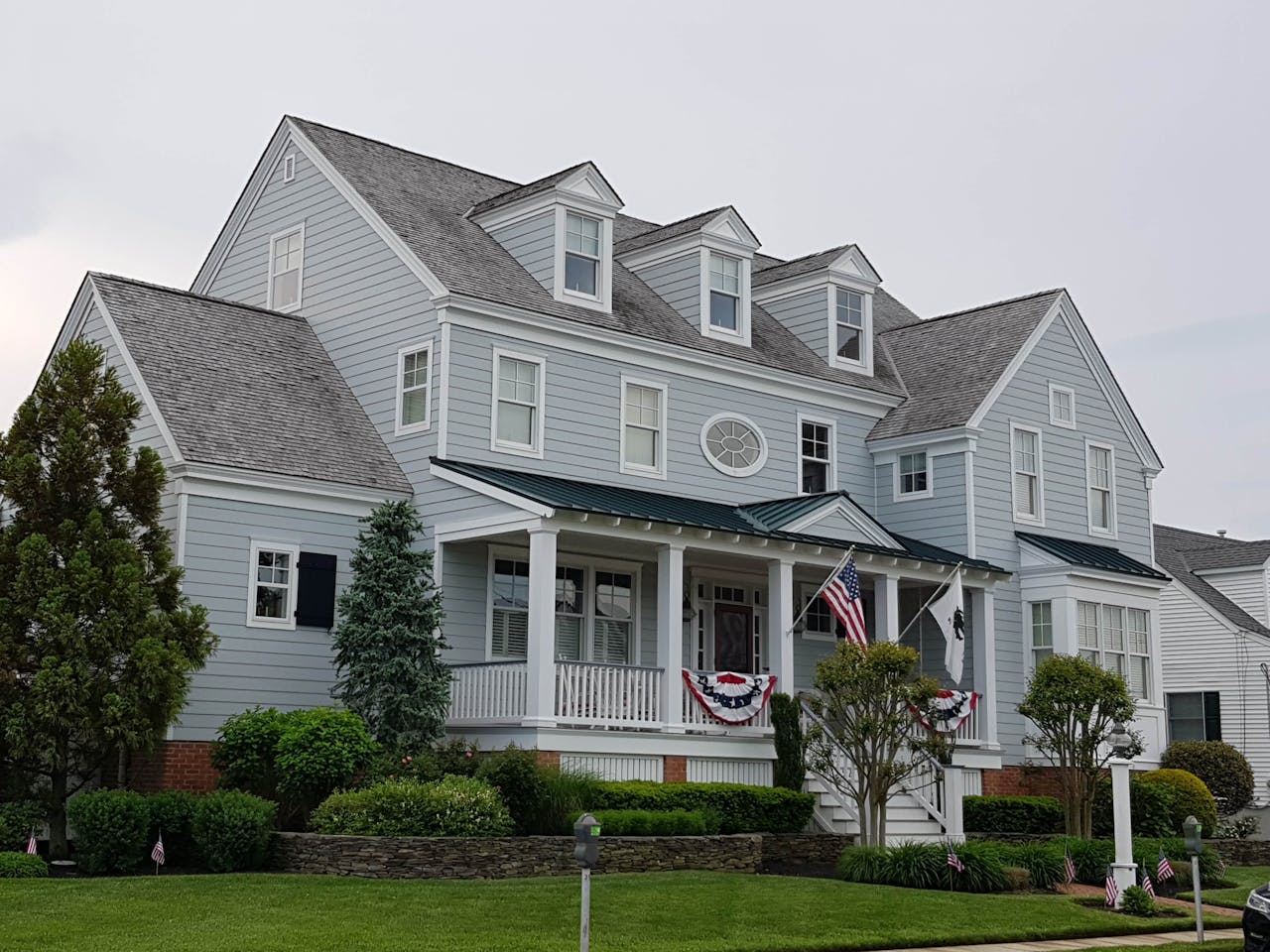 Home Elegant colonial-style house in Cape May, NJ with manicured lawn and American flags.
